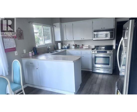 A kitchen with white cabinets and a large island.