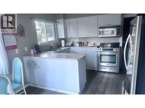 A kitchen with white cabinets and a large island.