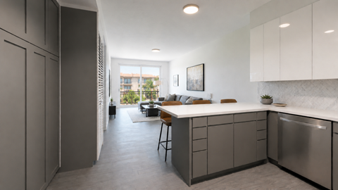 A modern kitchen with a dining table and chairs in the middle of the room.