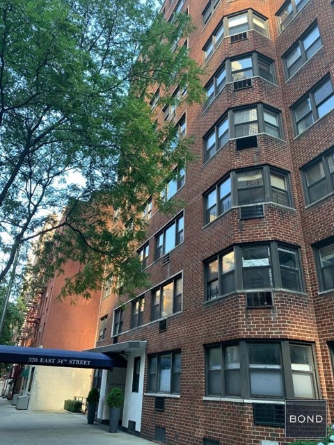 A tall brick building with a sign that says "Bond" on it.