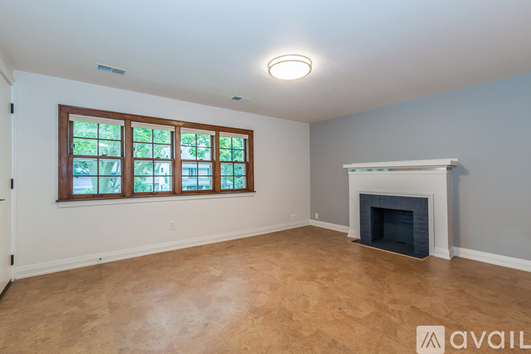 A room with a fireplace and a window.