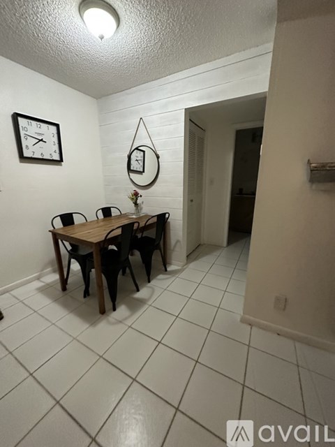 A dining room with a table and chairs.