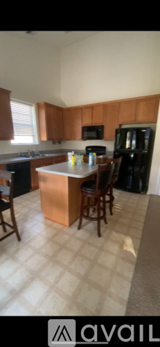 A kitchen with wooden cabinets and a white countertop.