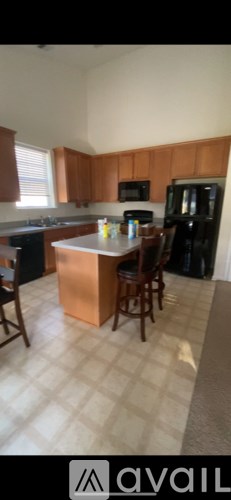 A kitchen with wooden cabinets and a white countertop.