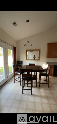 A dining room with a table and chairs.