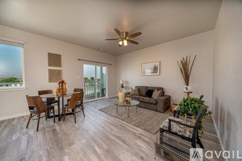 A living room with a dining table and chairs.