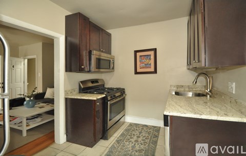A kitchen with a white counter top and a sink.