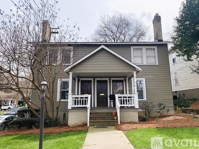 A house with a grey front and a white porch.