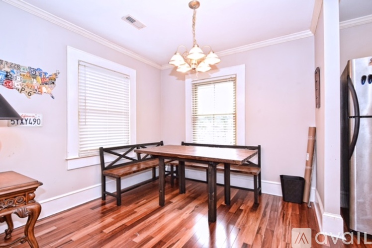 A dining room with a wooden table and chairs.