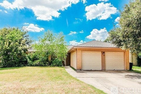 A detached house with a garage is for sale.