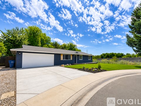 A house with a garage and a driveway in front of it.