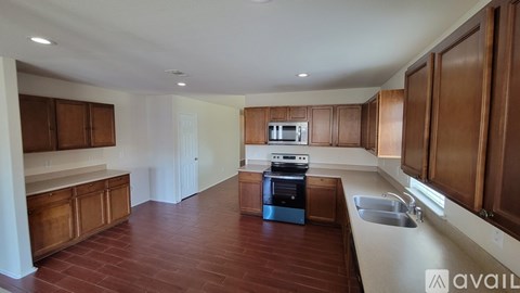 A kitchen with brown cabinets and a black oven.