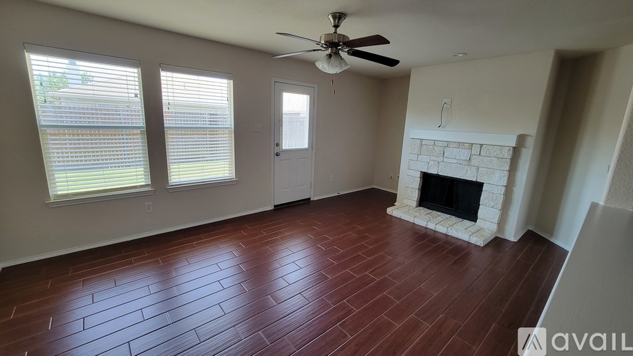 A room with a fireplace and a fan.