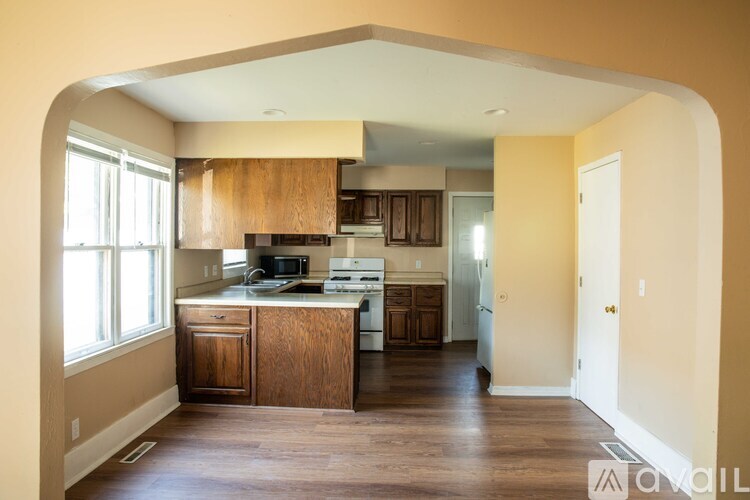 A kitchen with wooden cabinets and a countertop.