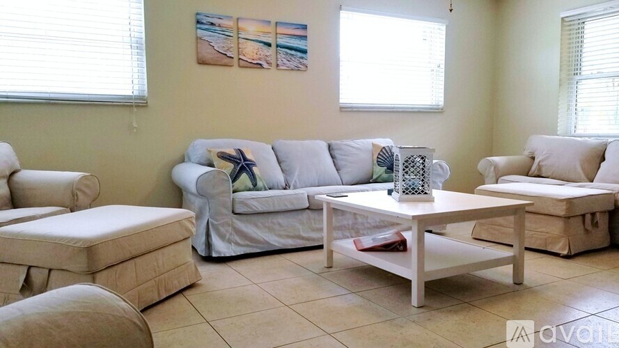 A living room with a white couch and a coffee table.