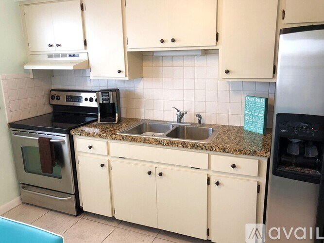 A kitchen with white cabinets and a granite countertop.