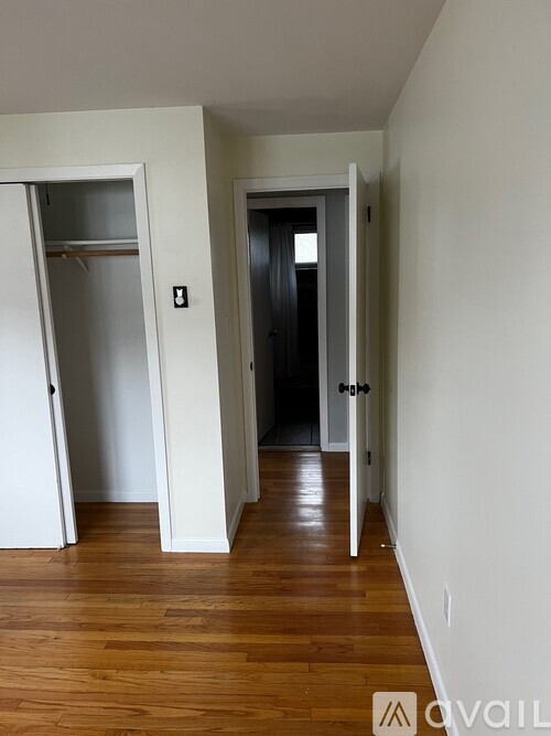 A hallway with two doors, one of which is open.
