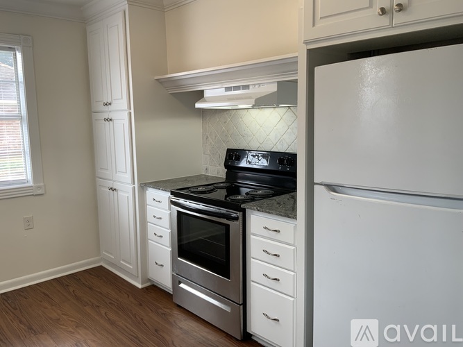 A kitchen with a stove, oven, and refrigerator.