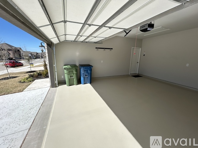 A spacious garage with a white ceiling and a concrete floor.