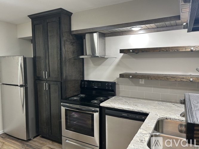A kitchen with a stove, oven, and refrigerator.