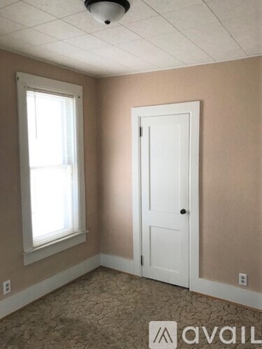 A room with a door, window and Avail logo on the floor.