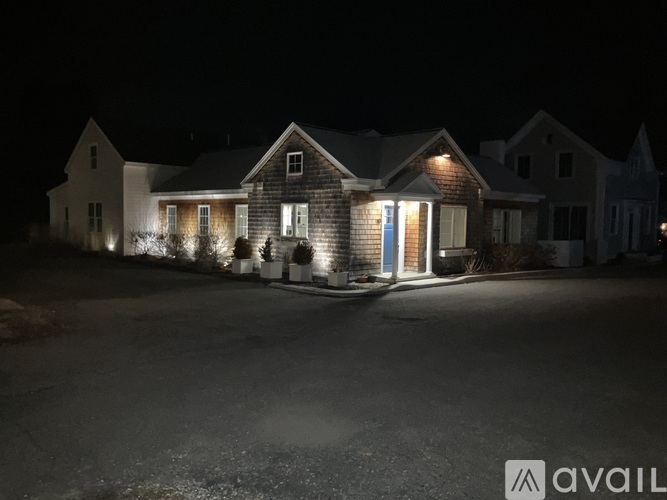 A house is lit up at night with the word "AVAIL" on the bottom right.