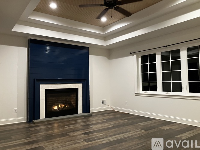 A room with a fireplace and a ceiling fan.
