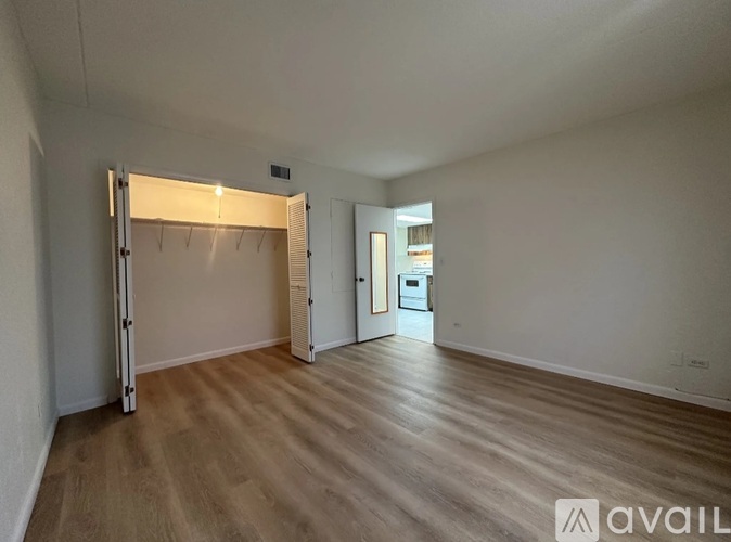 A room with wooden flooring and a sliding door.