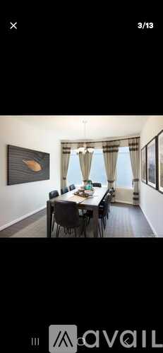 A dining room with a long table and chairs.