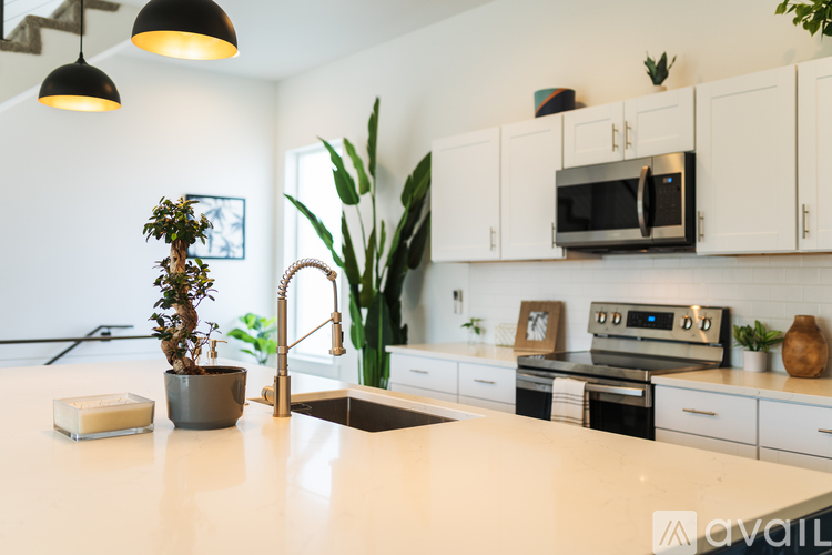 A kitchen with white cabinets and a white countertop.