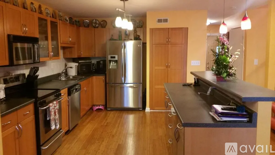 A kitchen with wooden cabinets and stainless steel appliances.