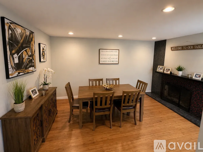 A dining room with a wooden table and chairs.