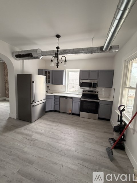 A modern kitchen with a grey floor and a large island.
