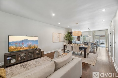 A modern living room with a large television and a comfortable couch.