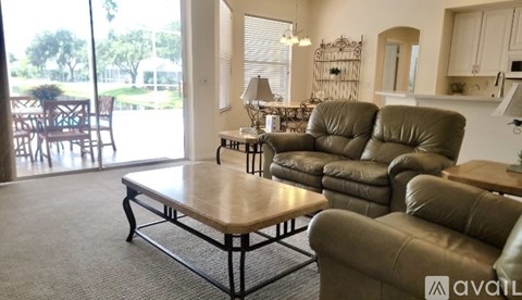 A living room with a table and chairs.