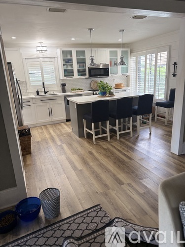 A kitchen with a dining table and chairs.