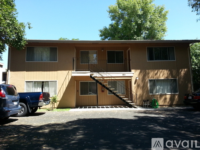 A two-story apartment building with a balcony on the second floor.