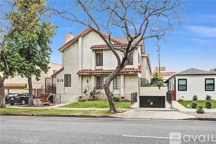A house with a tree in front of it.