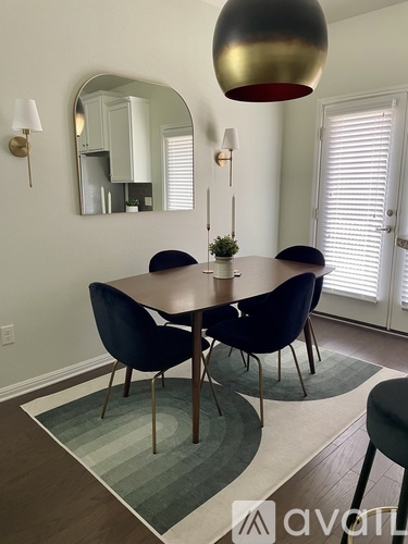 A dining room with a round table and chairs.