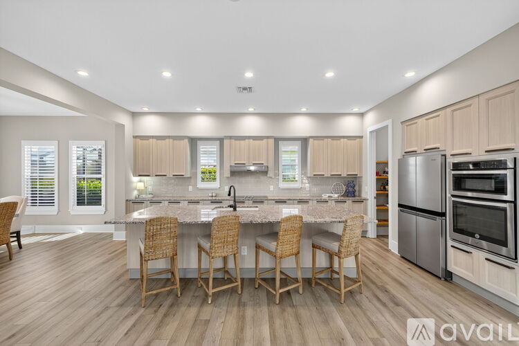 A kitchen with a table and chairs in the middle of the room.