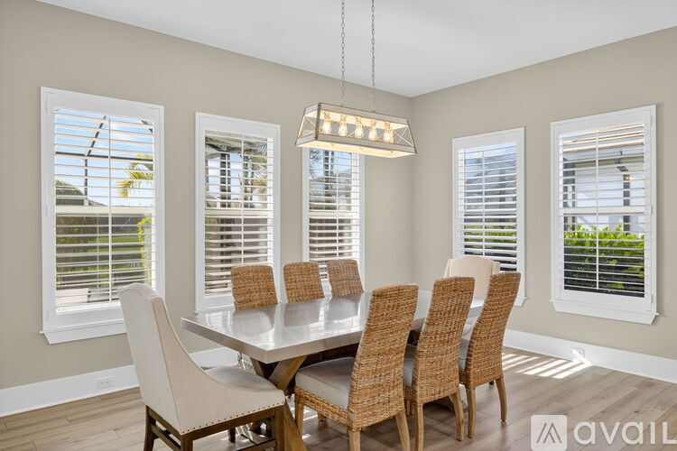 A dining room with a table and chairs.