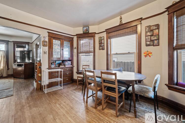 A dining room with a table and chairs.