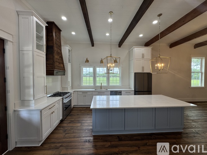 A modern kitchen with white cabinets and a large island.