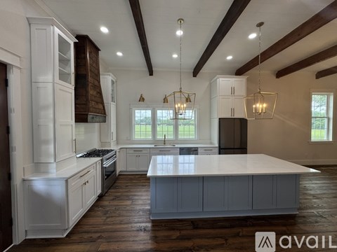 A modern kitchen with white cabinets and a large island.