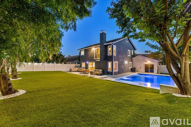 A house with a pool in the backyard.