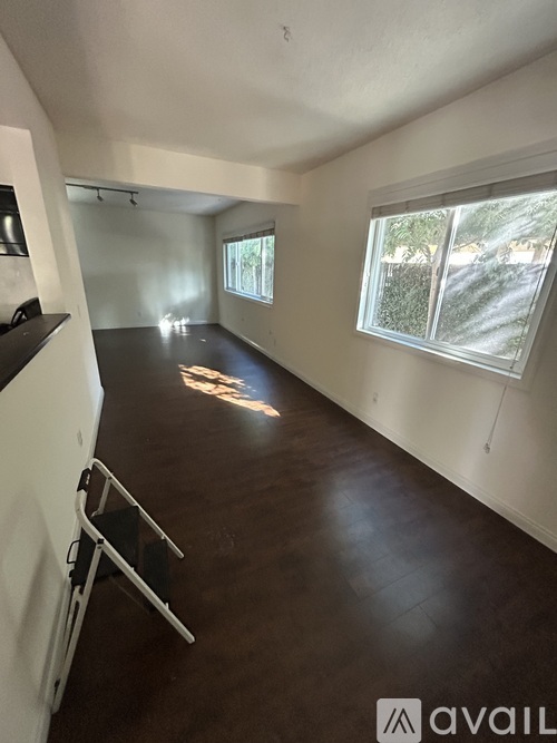 A room with white walls and a wooden floor.