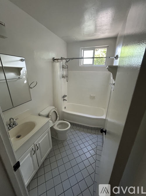 A bathroom with a toilet, sink, and bathtub.