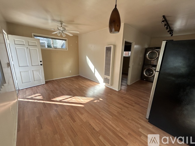 A room with wooden floors and a white door.