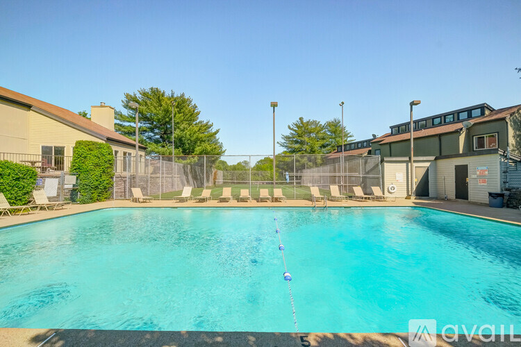A swimming pool with a blue water and a white pole in the middle.