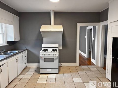 A kitchen with a stove and sink.